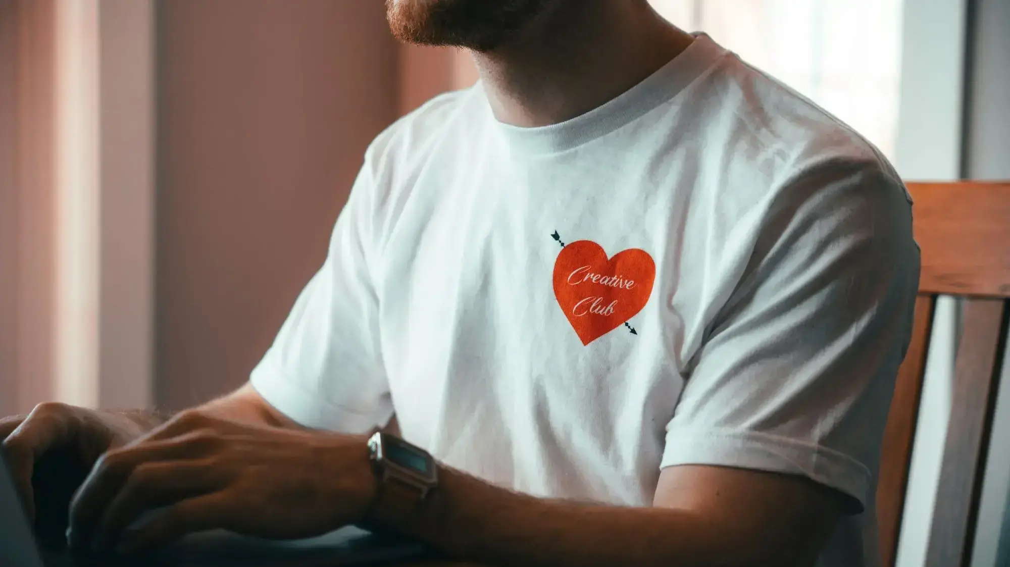 Man in t-shirt working on computer